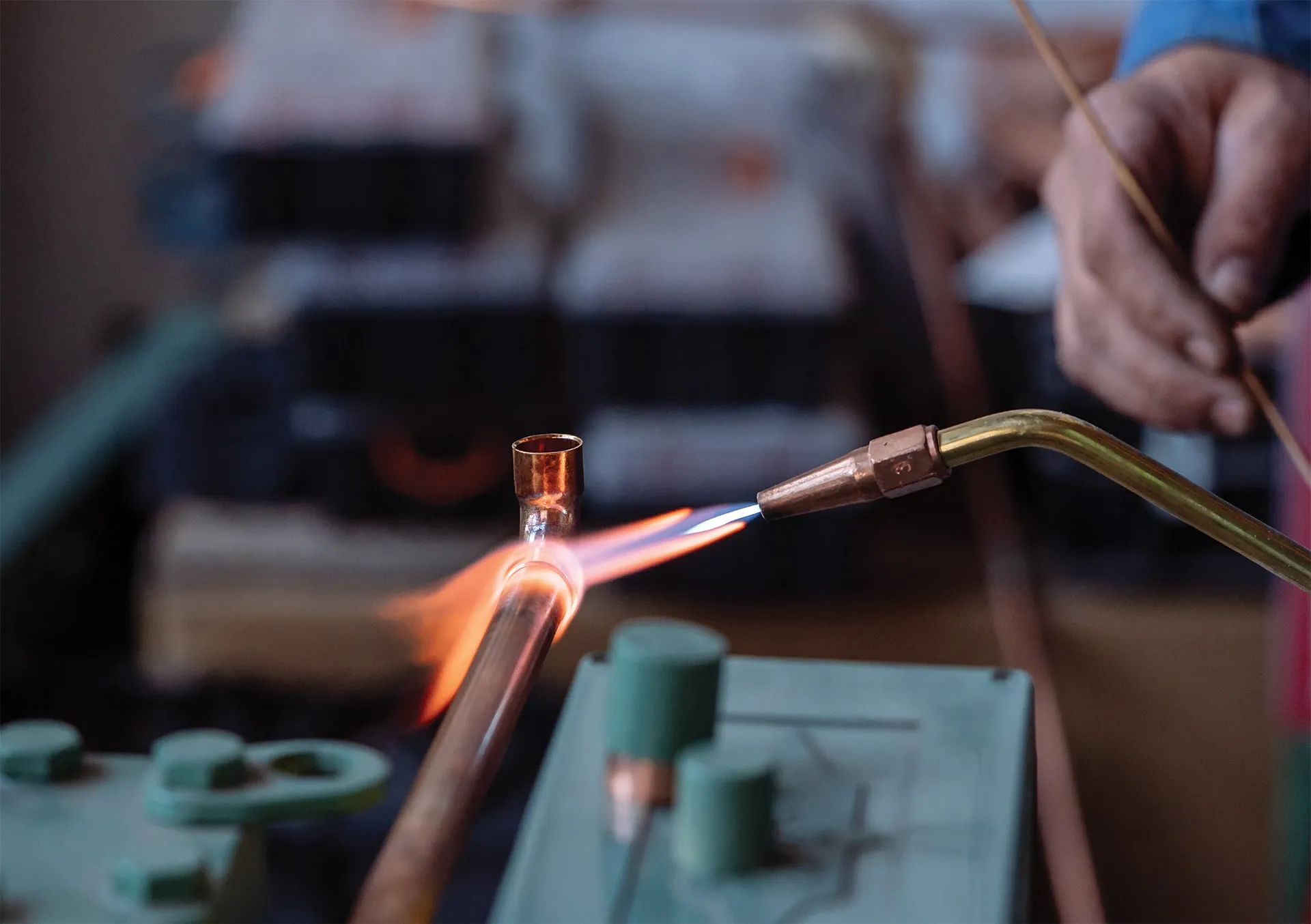 Technician soldering copper pipe for HVAC repair