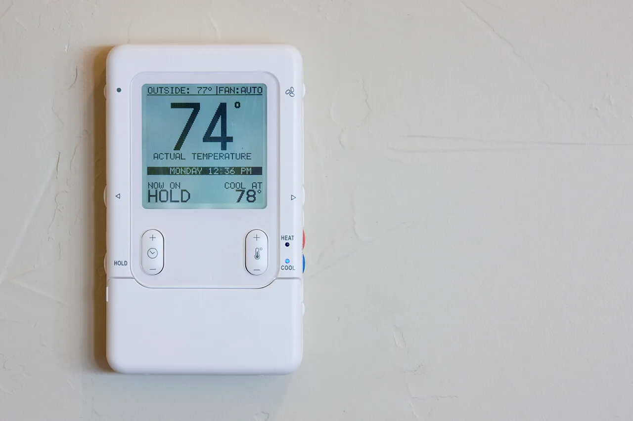Programmable thermostat digital display on wall
